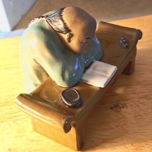 vintage Asian Mudman reading Book At Table